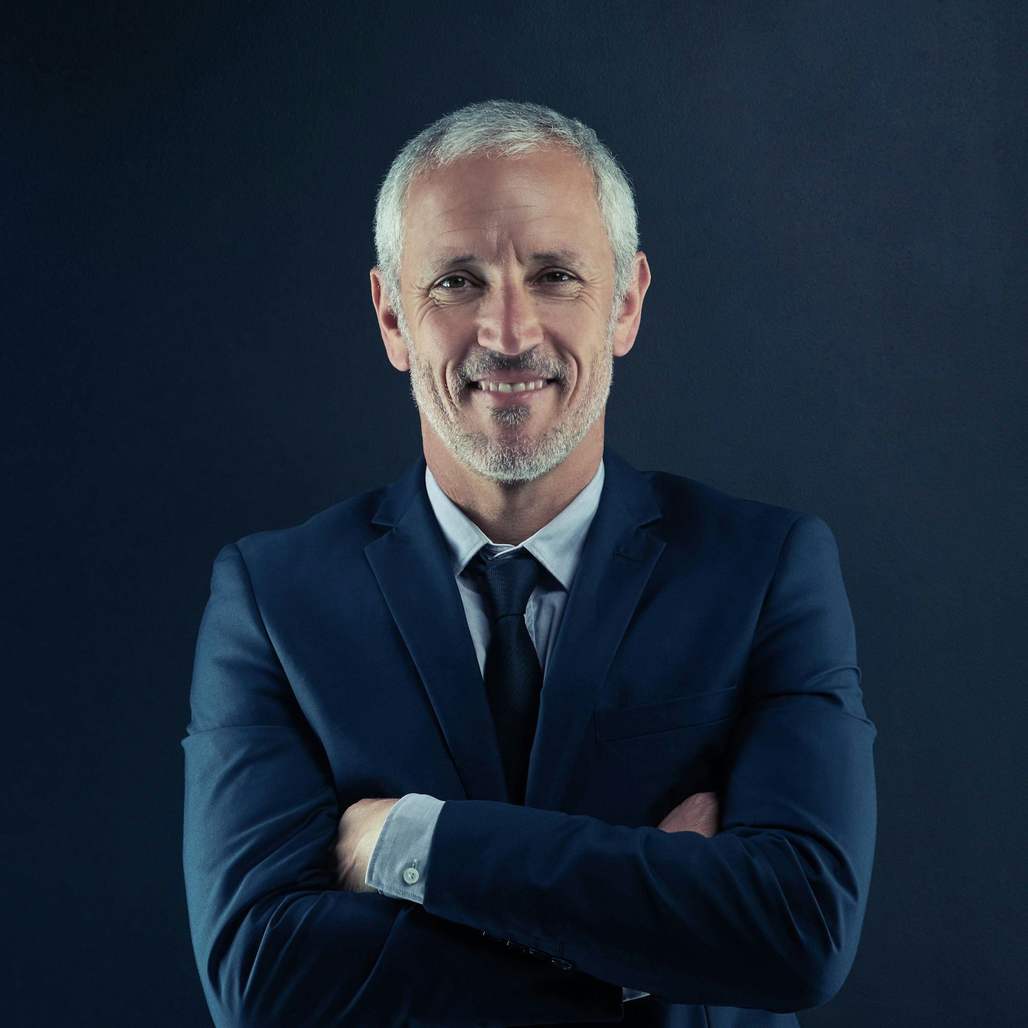 Inicio 2 studio portrait of a mature businessman against a dark background